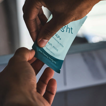 Opening a single-application sachet of Bright PAP+ whitening strips